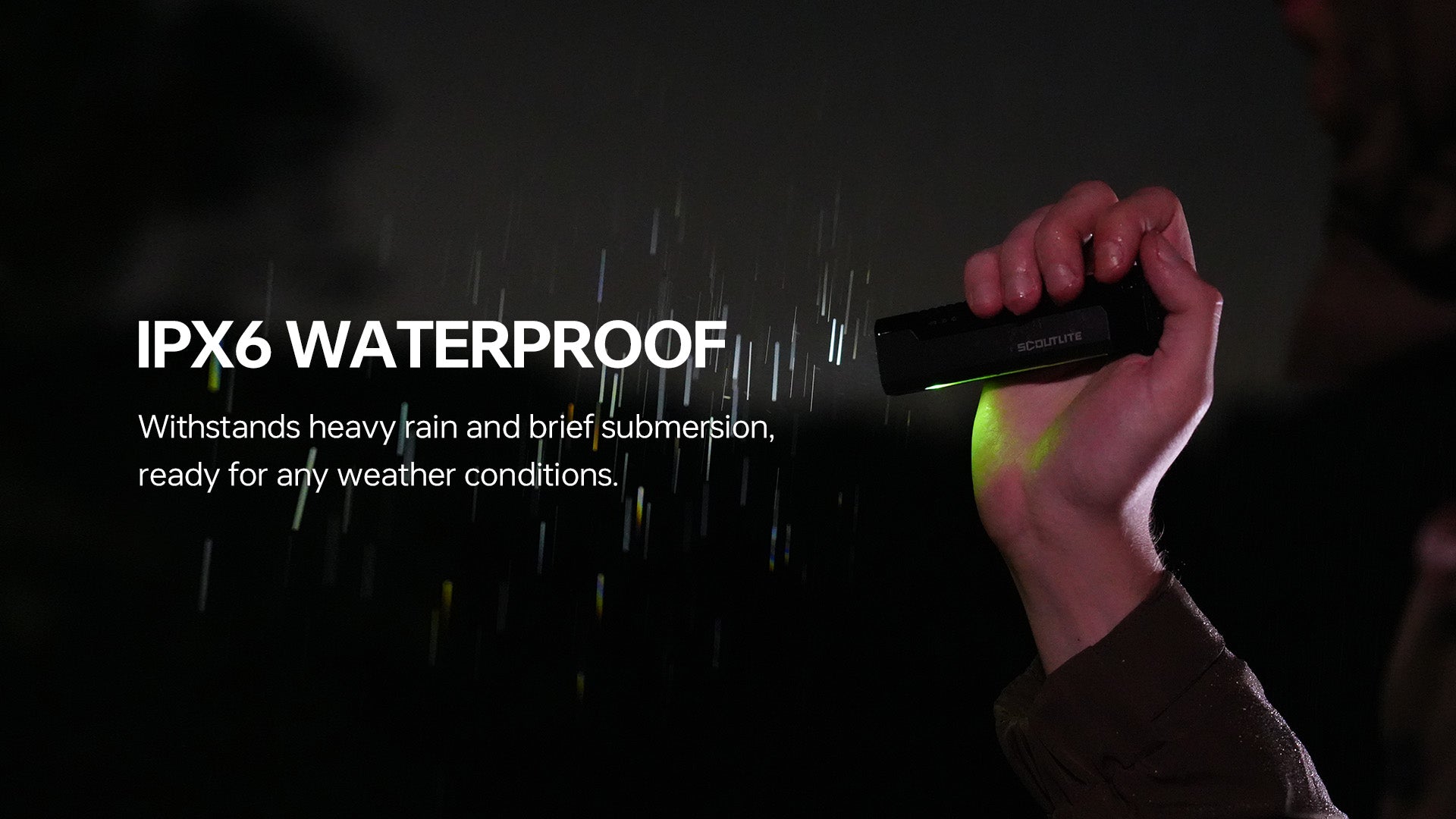 IPX6 waterproof flashlight held in heavy rain